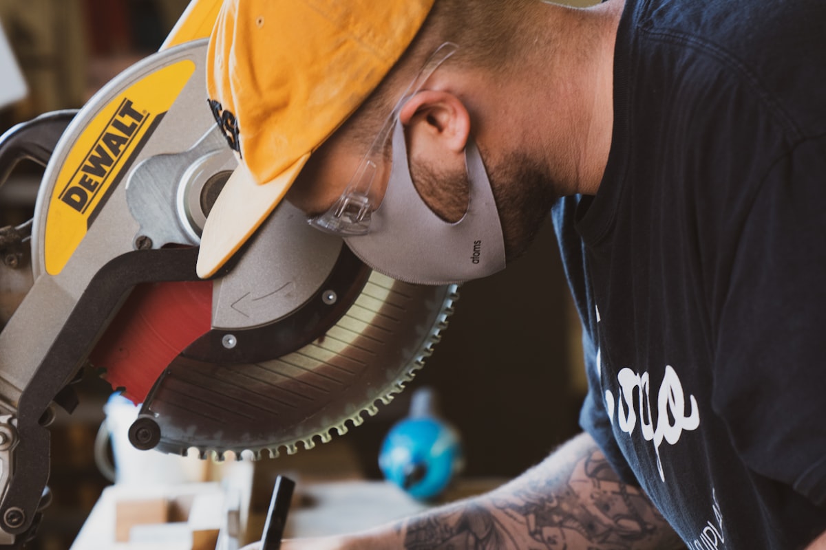 Joiner working at a mitre saw in a workshop